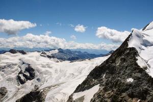 DIMEX | Vliesová fototapeta Švýcarské Alpy MS-5-1629 | 375 x 250 cm| modrá, bílá, černá
