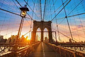 DIMEX | Vliesová fototapeta Brooklyn Bridge při západu slunce MS-5-2966 | 375 x 250 cm | modrá, žlutá, hnědá