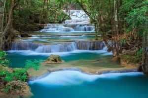 DIMEX | Vliesová fototapeta Kaskádový vodopád v lese MS-5-3250 | 375 x 250 cm | zelená, modrá, bílá, hnědá