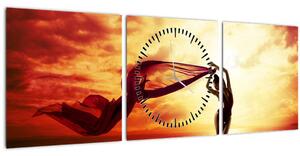 Obraz - Silueta ženy v západu slunce (s hodinami) (90x30 cm)
