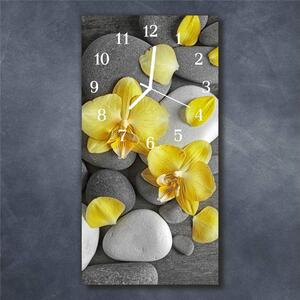 Nástěnné hodiny obrazové na skle - Orchidej žlutá na kamení