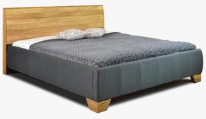 Látková postel v tmavé barvě s dřevěným čelem