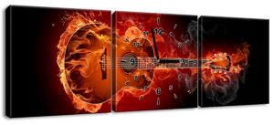 Obraz s hodinami Hořící kytara - 3 dílný Rozměry: 90 x 30 cm