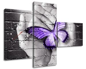 Obraz s hodinami Fialový motýl na dlaních - 3 dílný Rozměry: 80 x 40 cm