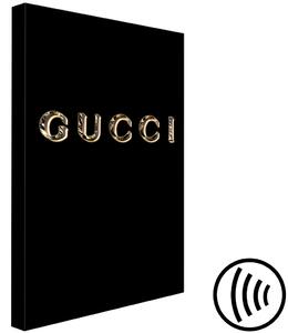 Obraz Gucci (1-dílný) svislý - zlatý název módní značky na černém pozadí