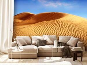 Fototapeta Poušť - zvlněné duny a horký písek na pozadí modré oblohy
