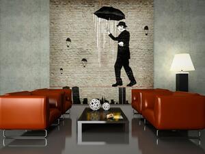 Fototapeta Charlie Chaplin - mural se siluetou muže s deštníkem na lince