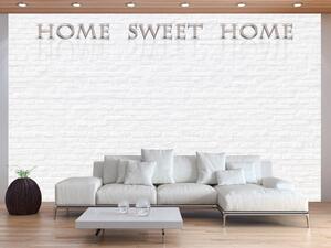 Fototapeta Home sweet home - béžový nápis se stínem a odrazem na bílé cihle