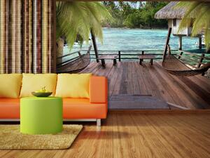 Fototapeta Tropická krajina - tyrkysová voda s palmami a dřevěnými domky