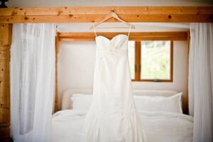 Umělecká fotografie Wedding dress hanging bed, Cavan Images, (40 x 26.7 cm)