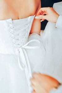 Umělecká fotografie Assistant Tie a Dress to the Bride, Valery Kudryavtsev, (26.7 x 40 cm)