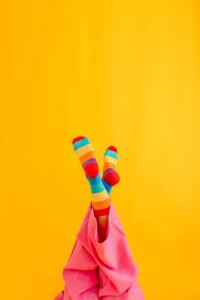 Fotografie Woman wearing colorful socks against yellow, Westend61, (26.7 x 40 cm)