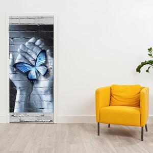 Fototapeta na dveře - Modrý motýl v dlaních (95x205cm)