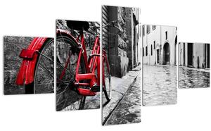 Obraz červeného kola na dlážděné ulici (125x70 cm)