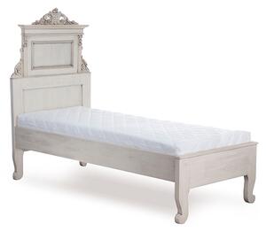 Repasovaná postel z masivního dřeva s ozdobnou řezbou