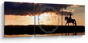 Obraz - Jezdec na koni při západu slunce (s hodinami) (90x30 cm)