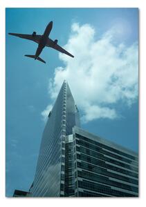 Vertikální Fotoobraz na skle Letadlo nad městem osv-83969980