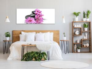 Obraz skleněný květ orchidej na kameni a hladině - 30 x 60 cm