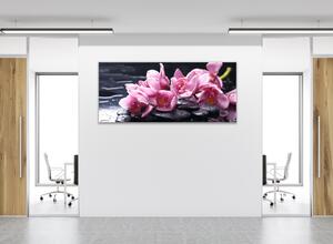Obraz skleněný fialové květy orchideje na oblázcích kamenech - 100 x 150 cm