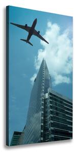 Vertikální Foto obraz na plátně Letadlo nad městem ocv-83969980