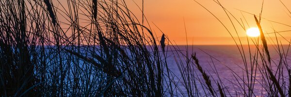 DIMEX | Fototapeta do kuchyně Západ slunce nad oceánem KI-180-203 | 180 x 60 cm | modrá, černá, oranžová