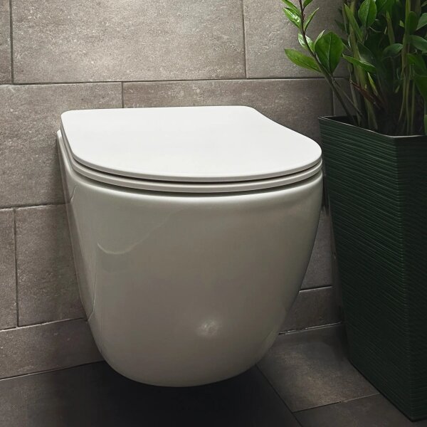 REA-C1259 - Závěsné WC s prkénkem CARLO MINI TORNADO RIMLESS keramika/lesk. bílá