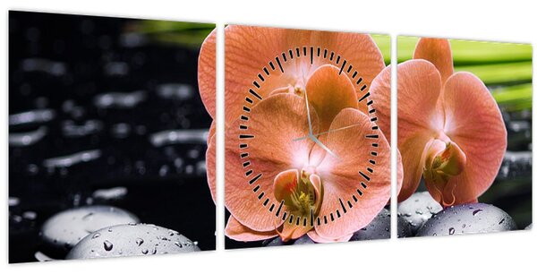 Obraz - Oranžová orchidej s palmovými listy (s hodinami) (90x30 cm)