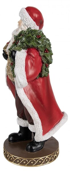 Červená vánoční dekorace Santa Claus na hnědém podstavci držící dárek a vánoční bobule – 23 cm