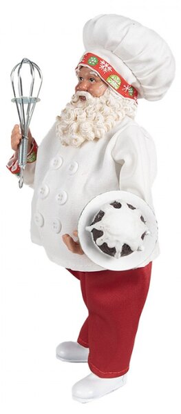 Bílá vánoční dekorace Santa Claus s kuchařskou čepicí držící dortík s polevou s metličkou – 27 cm