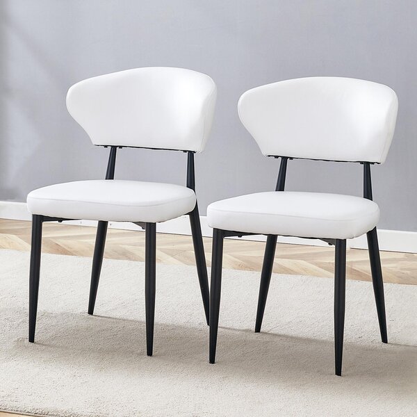 Bílá minimalistická ergonomická jídelní židle s prohnutou opěradlem, navržená pro pohodlí – otevírá způsob sezení, plný komfortu a jednoduché elegance. Balení obsahuje 2 židle. Bílá + černá