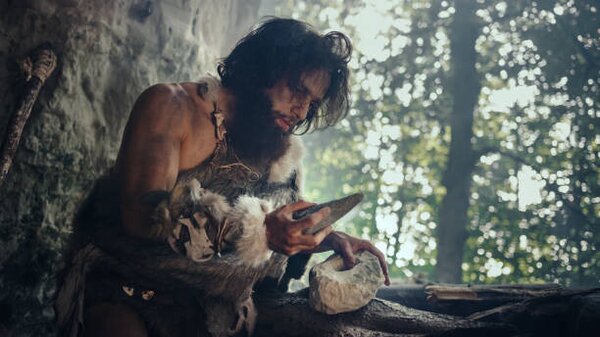 Ilustrace Primeval Caveman Wearing Animal Skin Holds, gorodenkoff