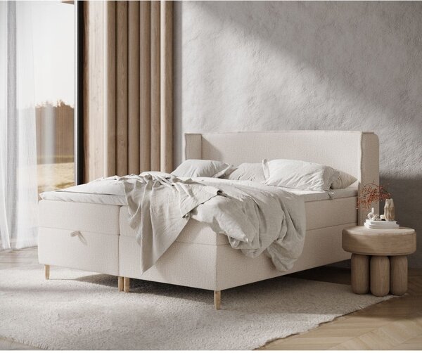 Krémová boxspring postel s úložným prostorem 180x200 cm Monpelli – Maison de Rêve