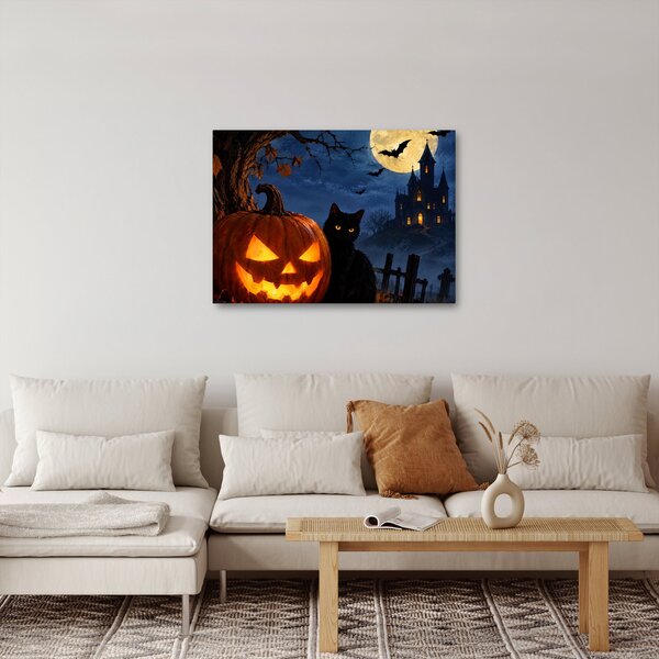 Obraz - Černá kočka u svítící dýně na Halloween (70x50 cm)