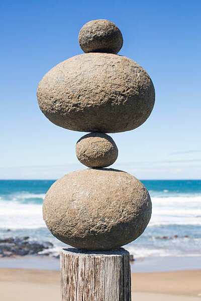 Umělecká fotografie Tower of rocks balancing on a wooden pole, Dimitri Otis, (26.7 x 40 cm)