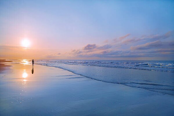 Fotografie Person walking on beach at sunrise, Shannon Fagan, (40 x 26.7 cm)