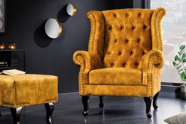 Chesterfield křeslo Cella se sametovým čalouněním v hořčicově žluté barvě s tmavě hnědými masivními nožičkami 105cm
