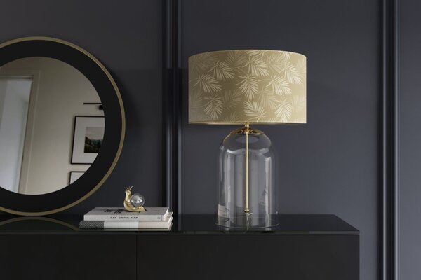 Glamour zlatá stolní lampa Gambier s kulatým stínítkem se vzorem palmových listů a průhlednou skleněnou podstavou 55 cm