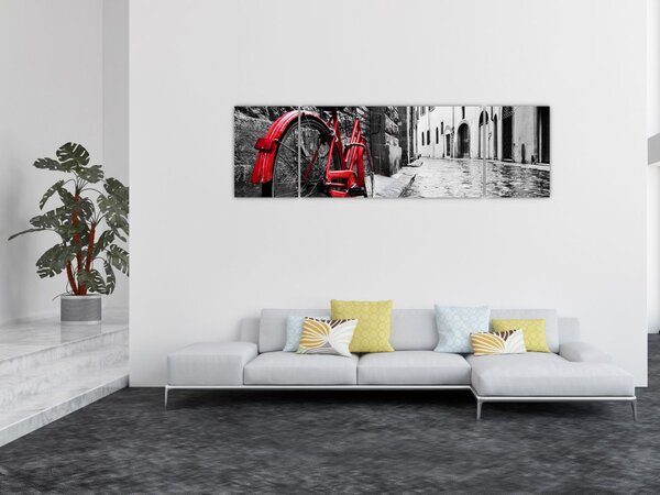 Obraz červeného kola na dlážděné ulici (170x50 cm)