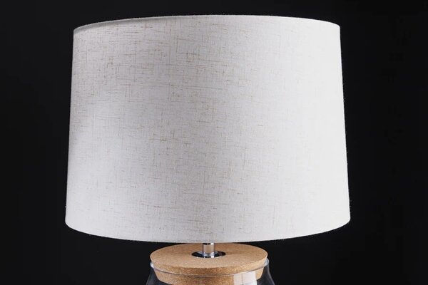 Stylová skleněná stolní lampa Clasico s nohou v podobě průsvitné nádoby s válcovým béžovým stínítkem 60 cm