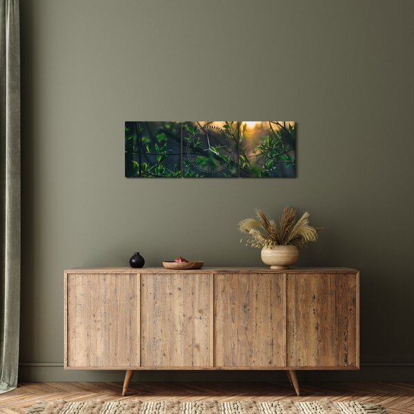 Obraz prosvítajícího slunce skrz větvičky stromů (s hodinami) (90x30 cm)