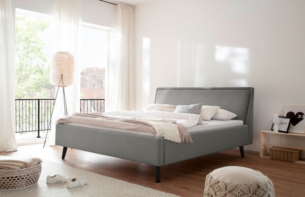 Světle šedá látková dvoulůžková postel Meise Möbel Frieda 140 x 200 cm s černou podnoží