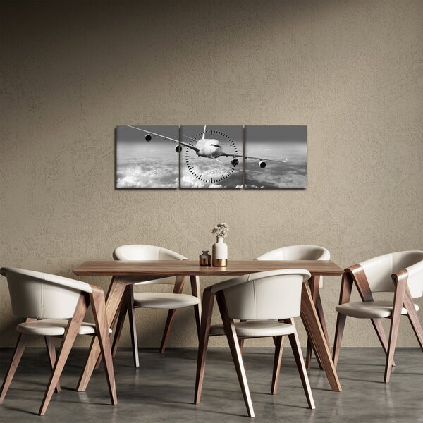 Obraz - Letadlo v oblacích, černobílé (s hodinami) (90x30 cm)